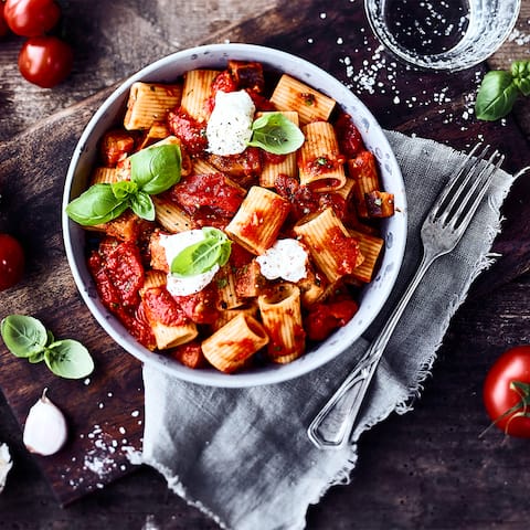 Ein traditionelles, leicht scharfes Gericht der sizilianischen Küche: Pasta alle Norma mit Auberginen, geschälten Tomaten, Nudeln und einem Klecks Ricotta. 