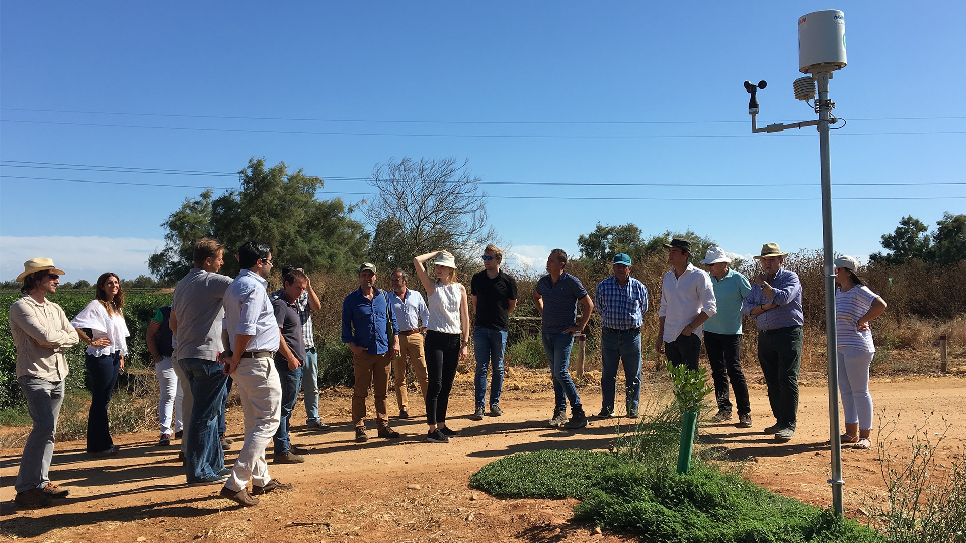 Ein Gruppe von Menschen, die in einem Kreis zusammenstehen und einer Person zuhören