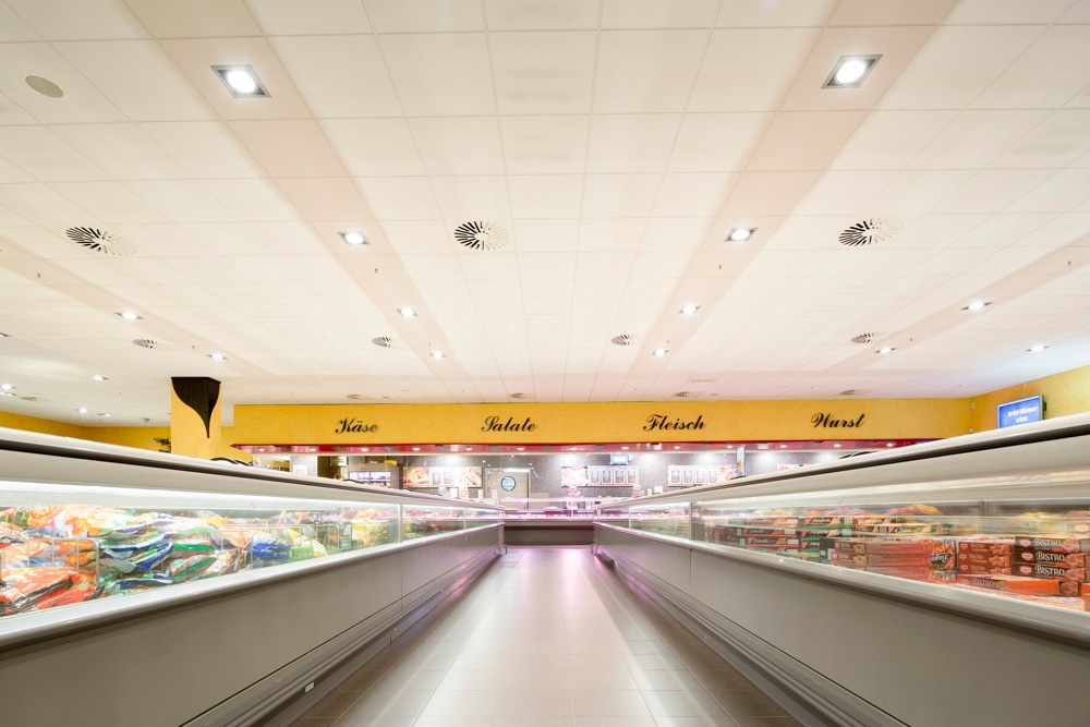 Langer Gang mit Tiefkühltruhen.