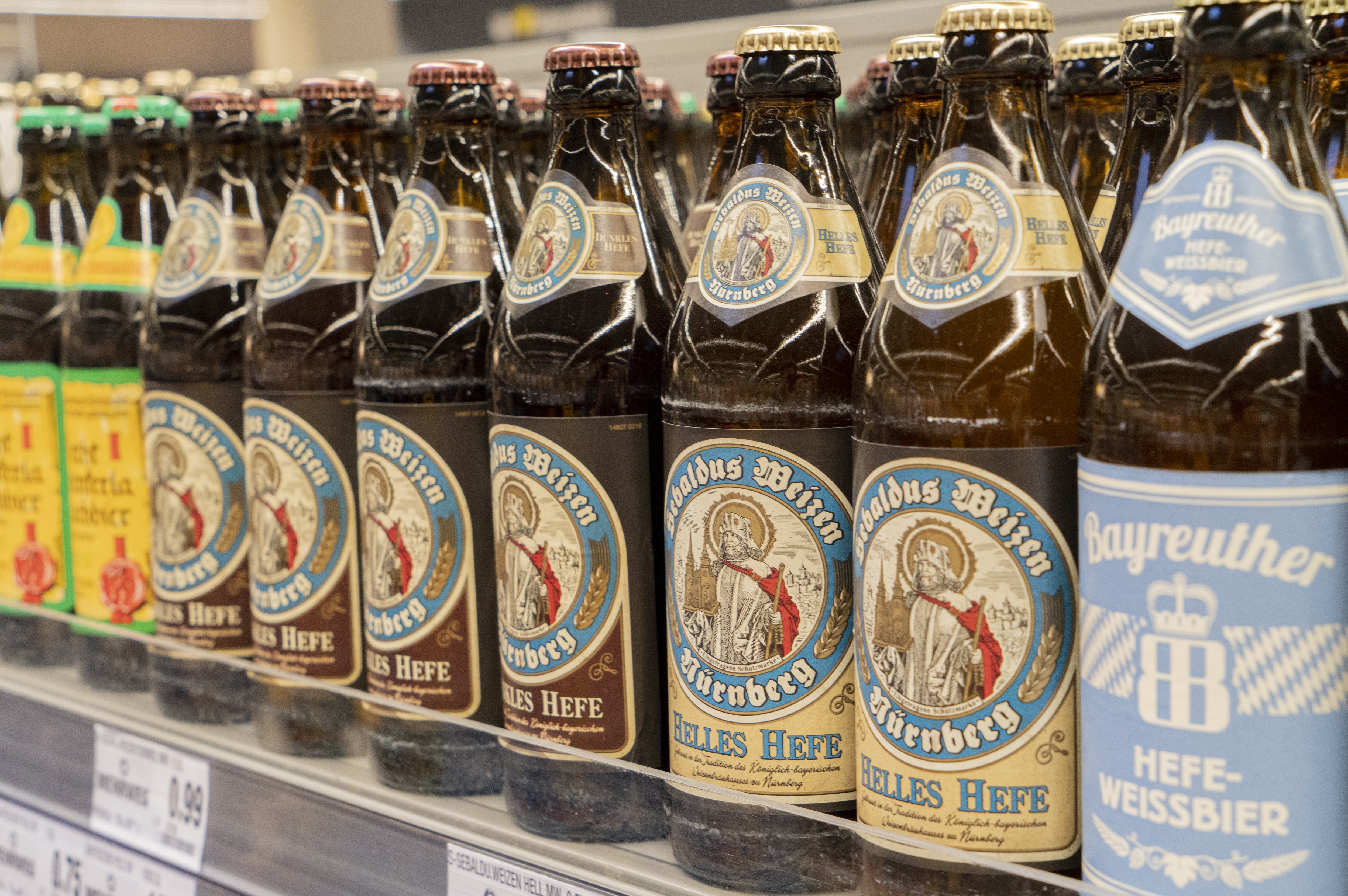 Close-Up einiger Bierflaschen von regionalen Marken mit mittelalterlichen Motiven auf den Etiketten.