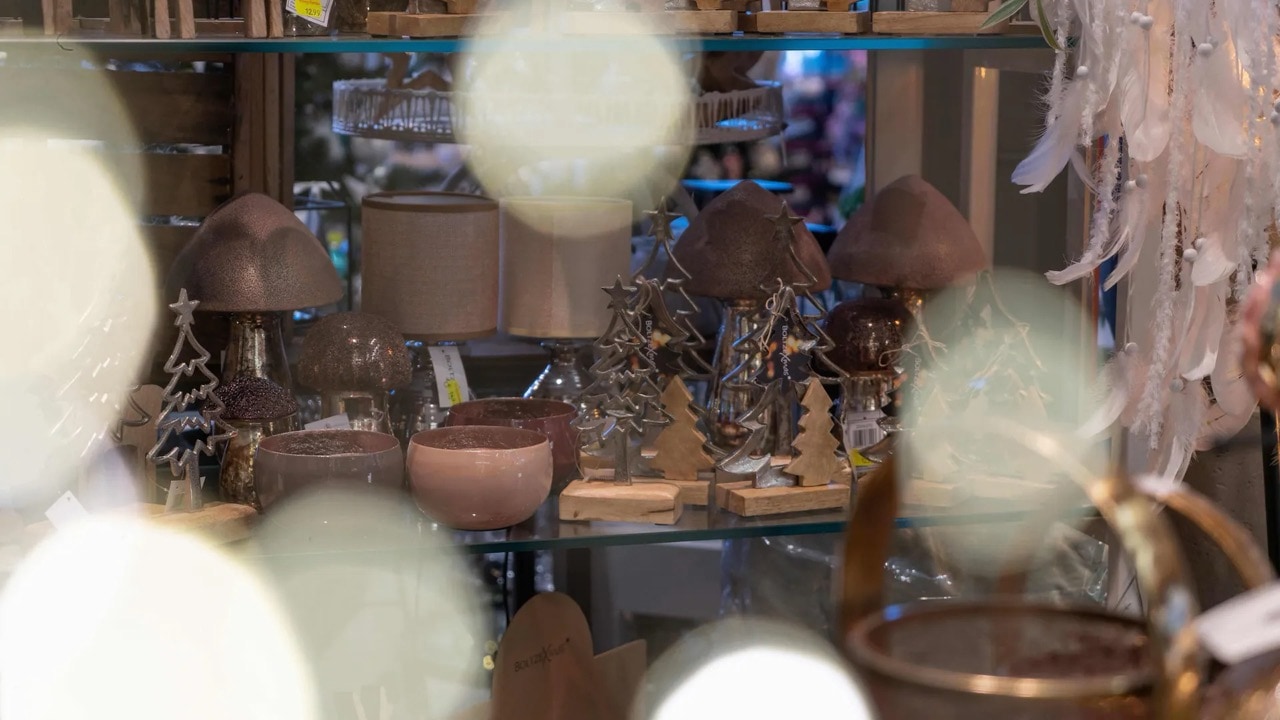 Verschiedene weihnachtliche Dekorationselemente in einem Regal.