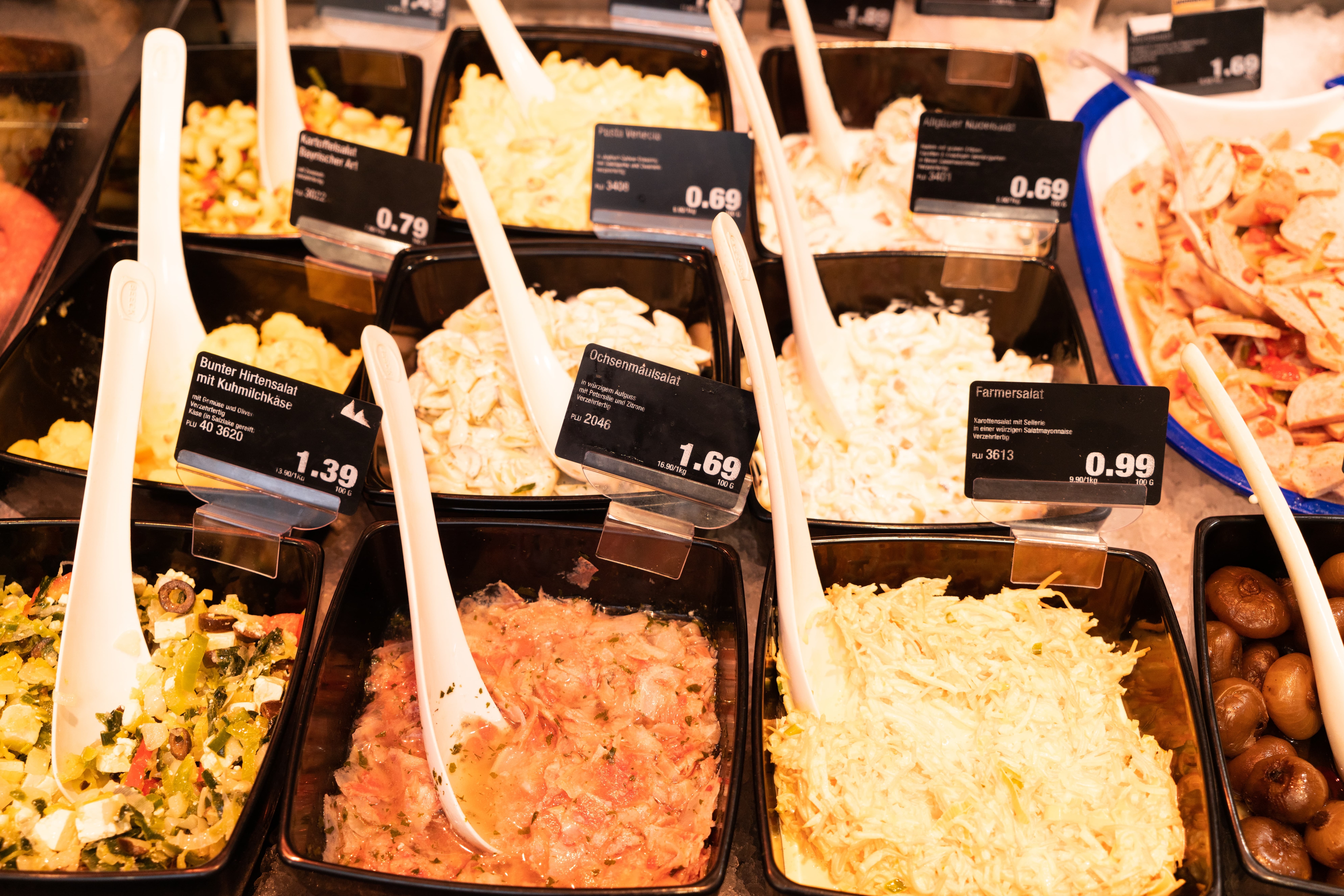 Schalen mit verschiedenen Salaten in der Frischetheke eines Edeka-Marktes.
