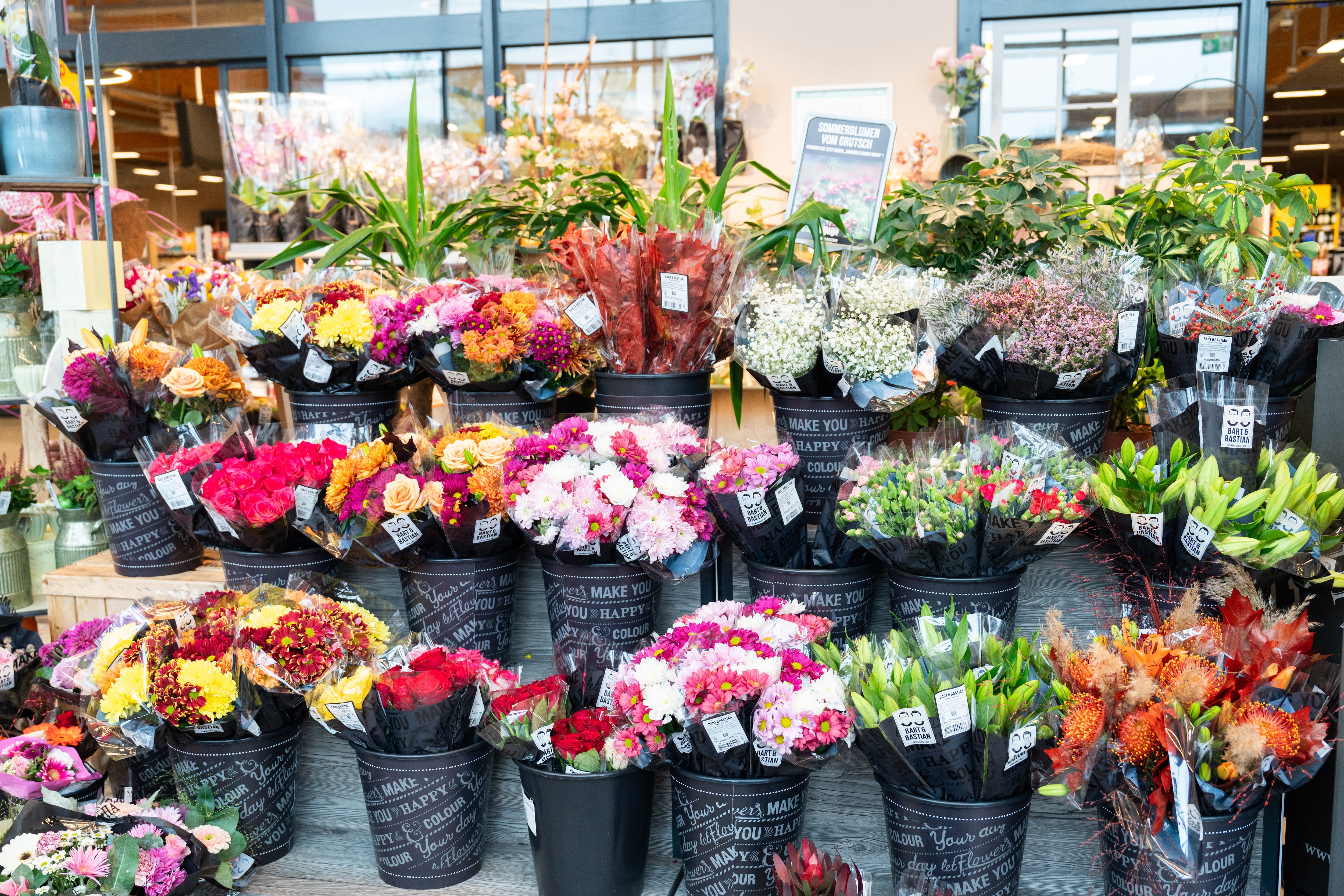 Ein Podest mit Eimern voller Schnittblumen.