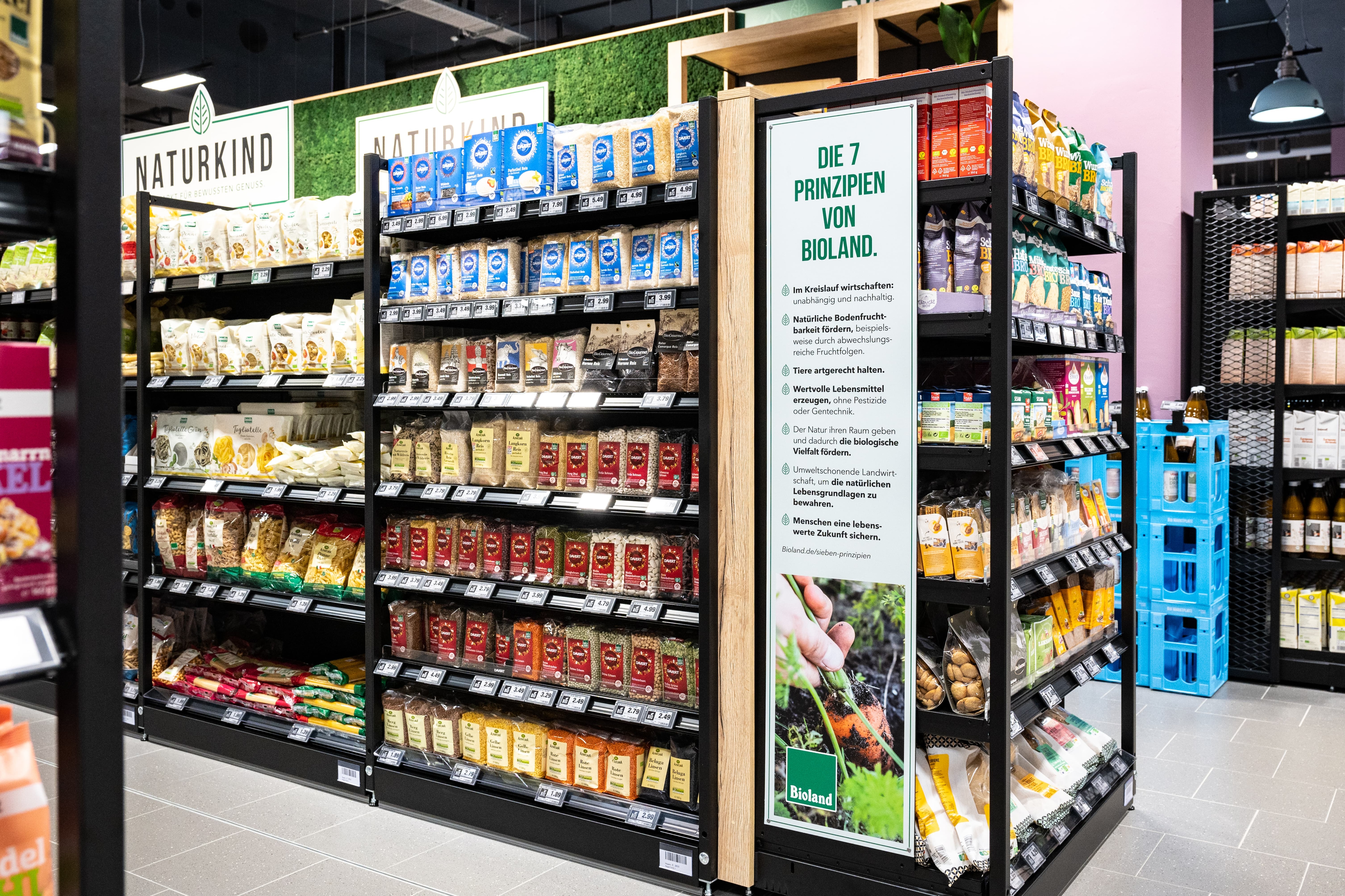 Ein Regal mit Bio-Produkten mit einem Schild auf dem die 7 Prinzipien von "Bioland" stehen.