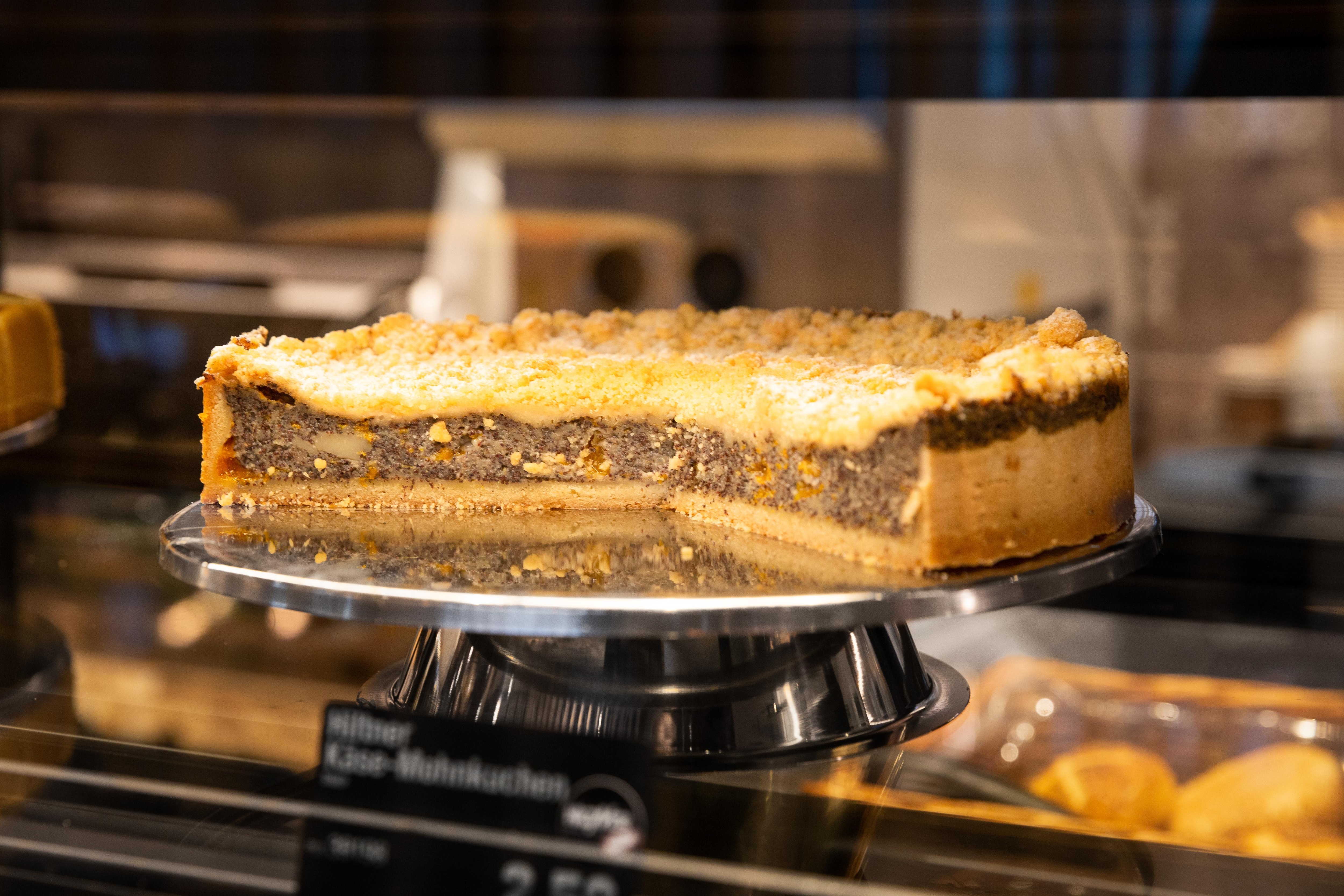 Ein angeschnittener Kuchen in der Auslage einer Bäckerei.