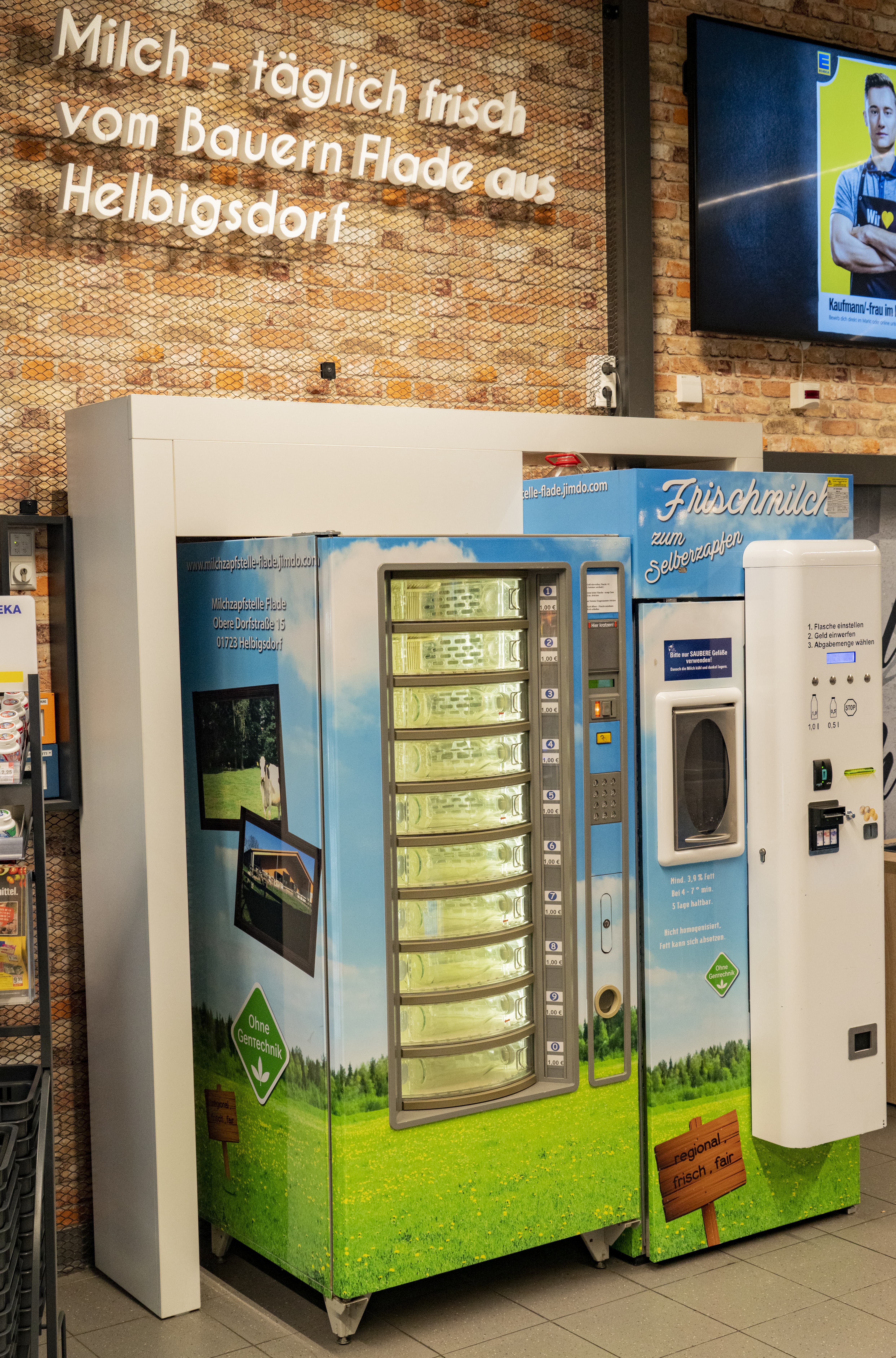 Eine Frischmilchzapfstelle, aufgebaut wie ein Snack- oder Getränkeautomat, im Eingangsbereich eines EDEKA-Markts.