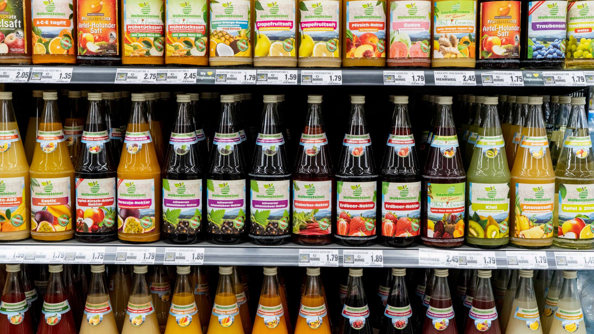 Ein Regal mit verschiedenen Säften in Glasflaschen.