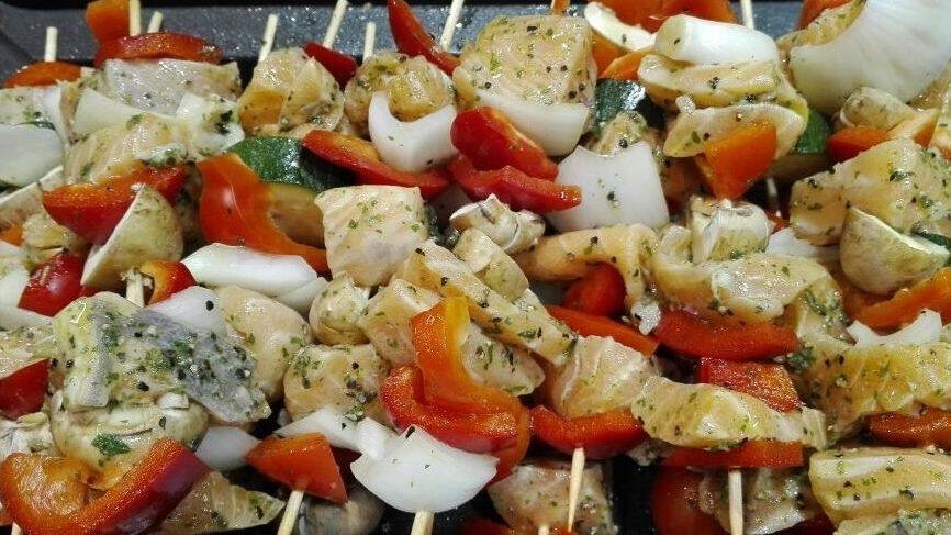 Nahaufnahme von Fischspießen mit Gemüse.