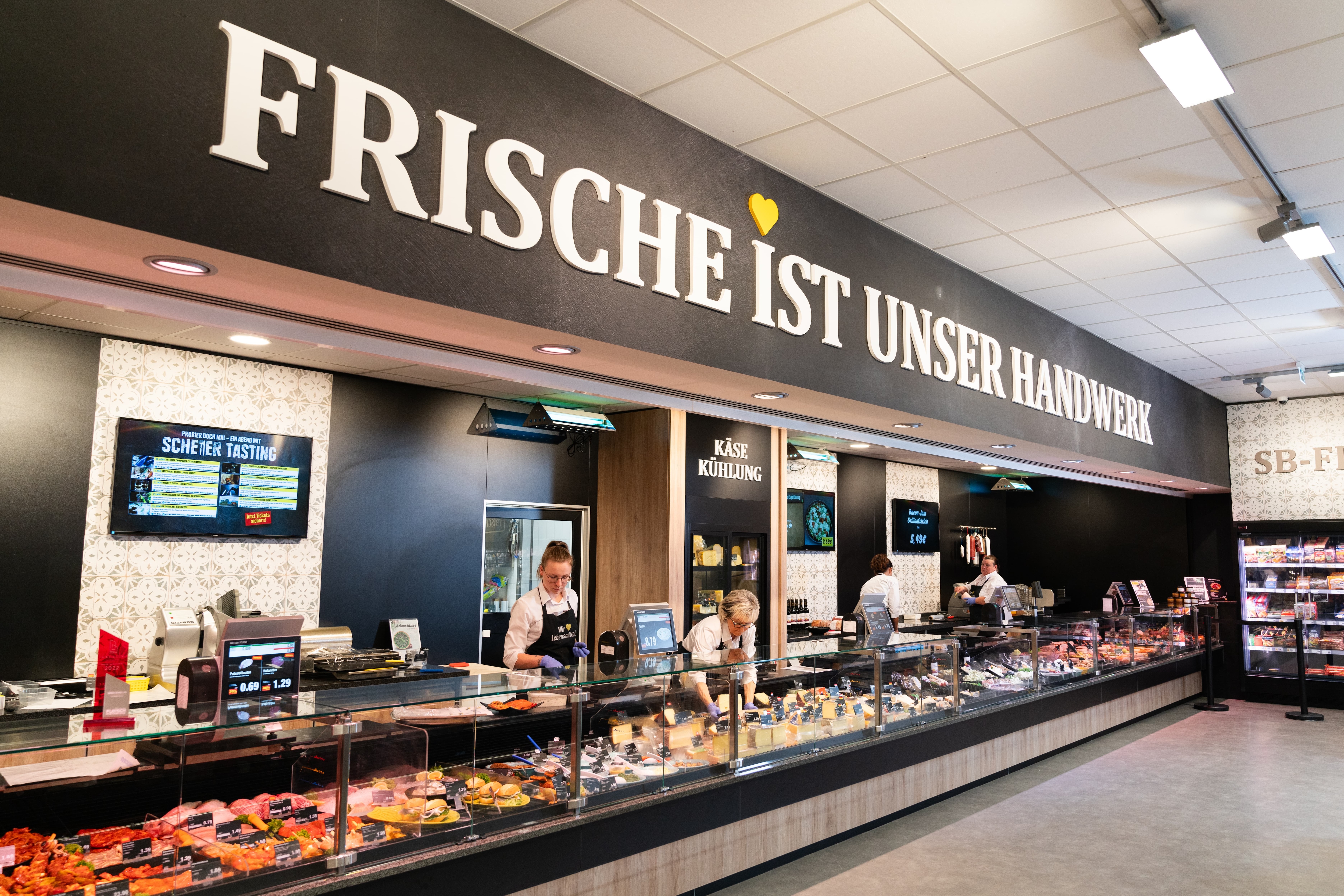 Über der Frischetheke ist ein großer Schriftzug: Frische ist unser Handwerk.