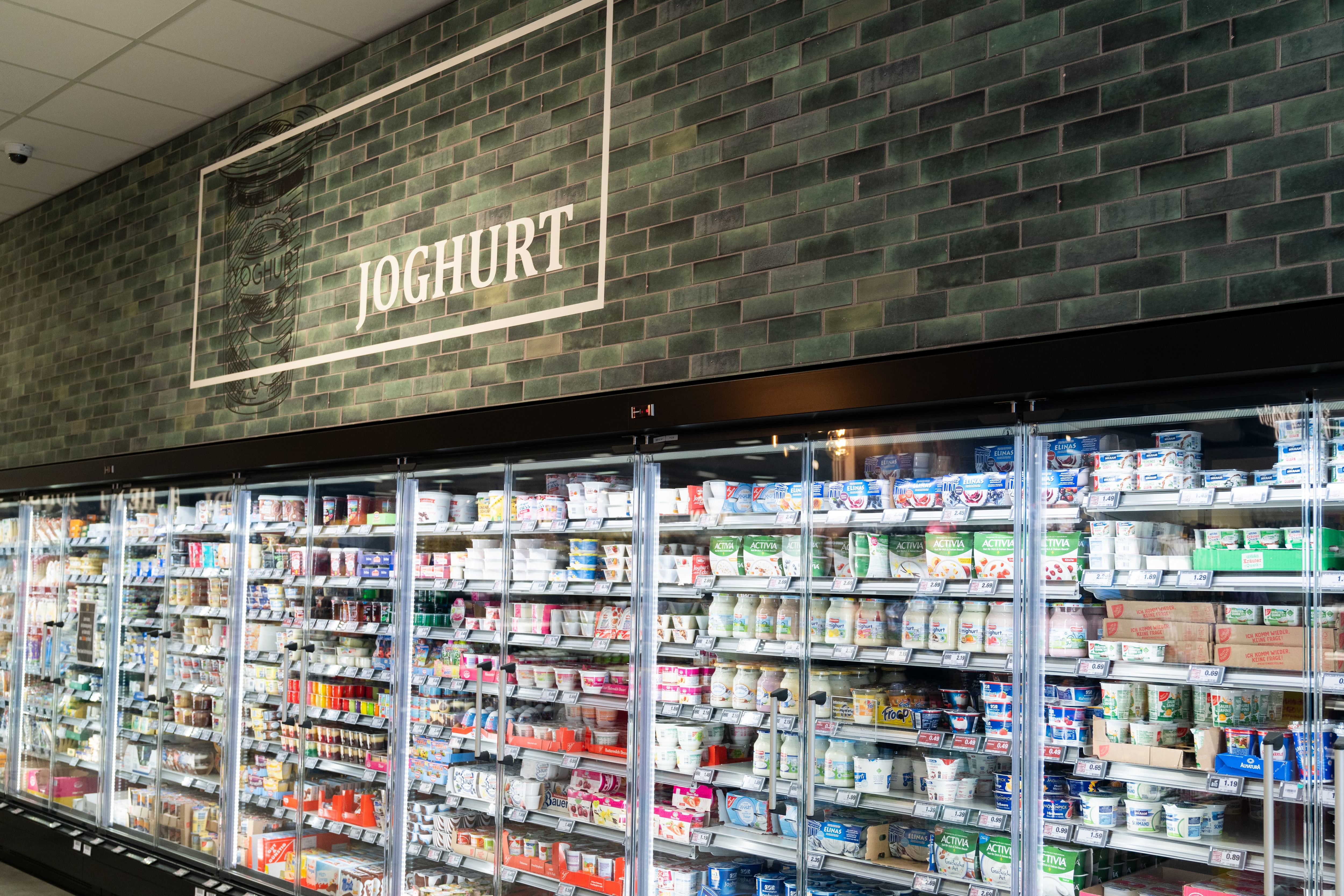 Kühlschränke mit Molkereiprodukten. Darüber steht Joghurt.