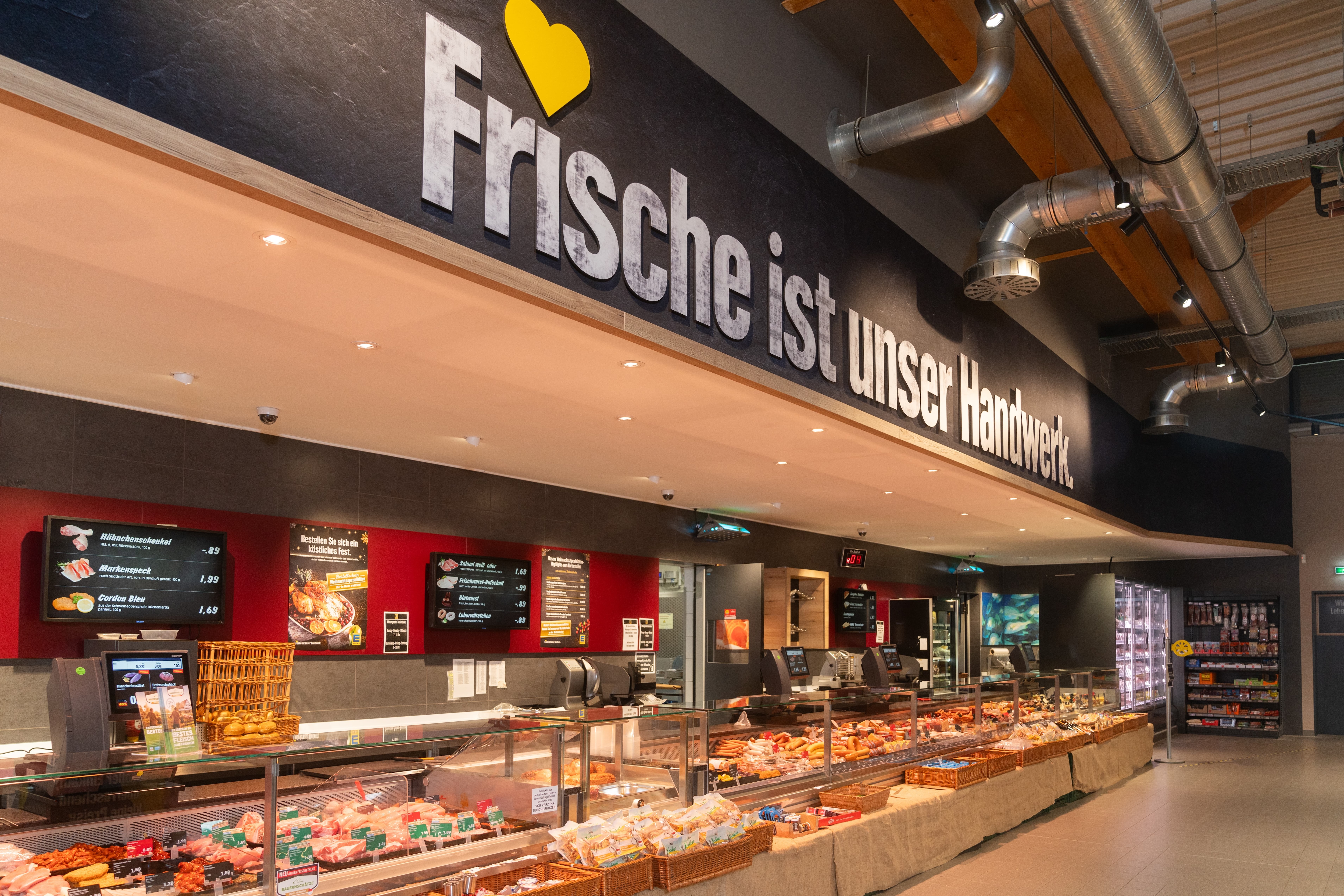 Über der Frischetheke ist ein großer Schriftzug: Frische ist unser Handwerk.