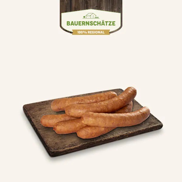 Sechs fränkische Brotzeitwürstle auf einem Holzbrett.