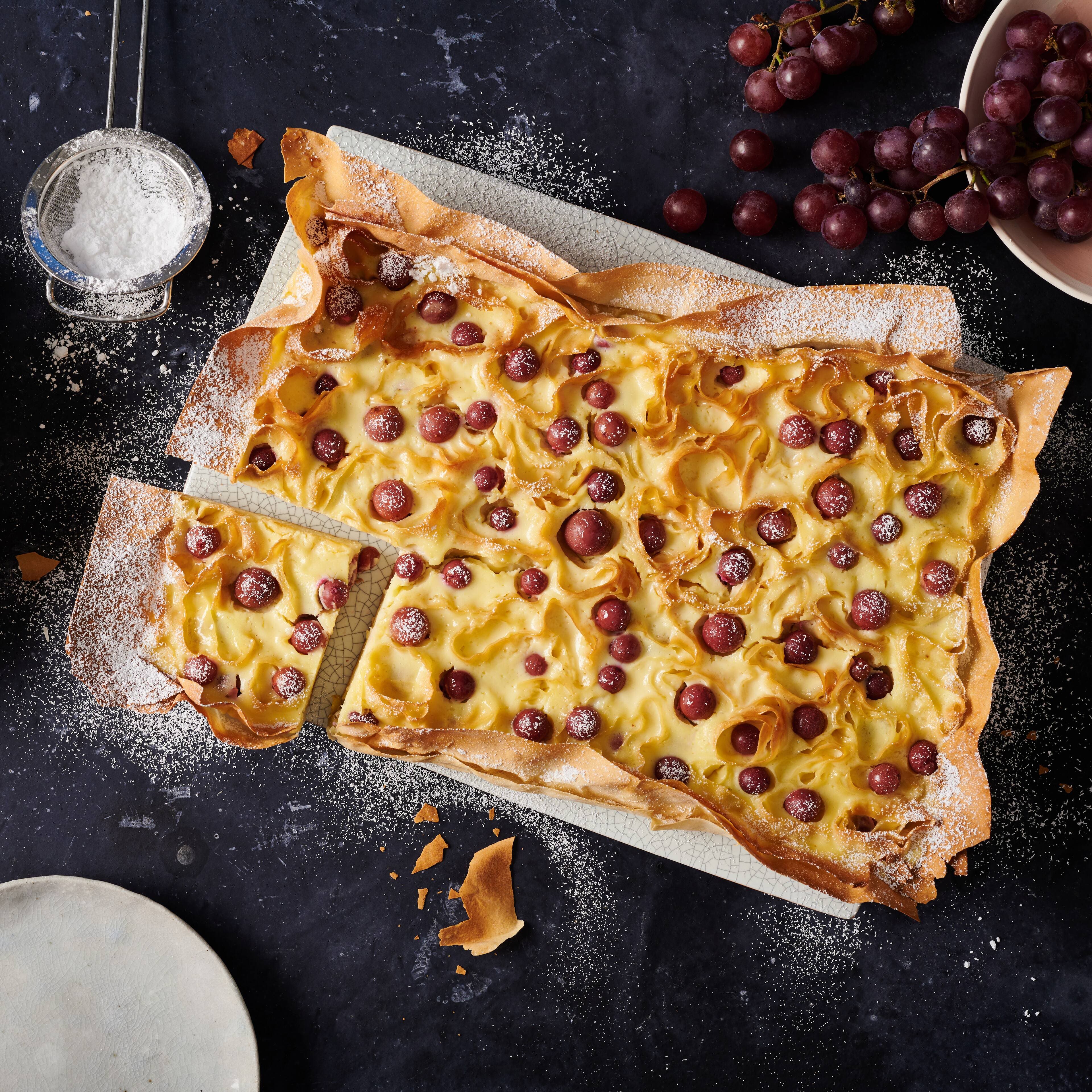 Es ist Kuchenzeit! Und zwar diesmal mit einem ganz besonderen Kuchen: Probieren Sie unser Rezept für einen selbstgemachten Ricotta-Kuchen mit Filoteig und roten Trauben.