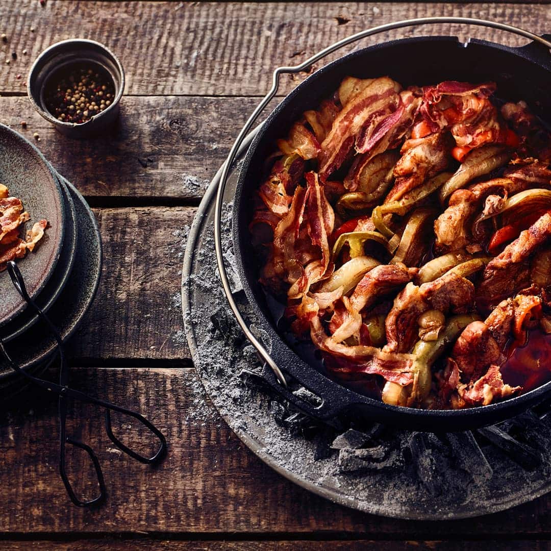 Der Klassiker aus dem Dutch Oven (oder einem hohen Schmortopf): Zartes Schichtfleisch mit Paprika und Bacon.
