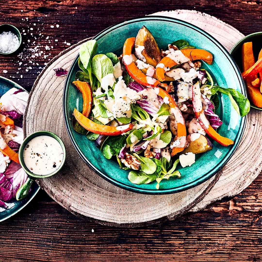 Erfrischende Zwischenmahlzeit: Probieren Sie unseren herbstlichen Salat mit Käse mit Feldsalat, Pflaumen, Hokkaido-Kürbis und Ziegenkäse.