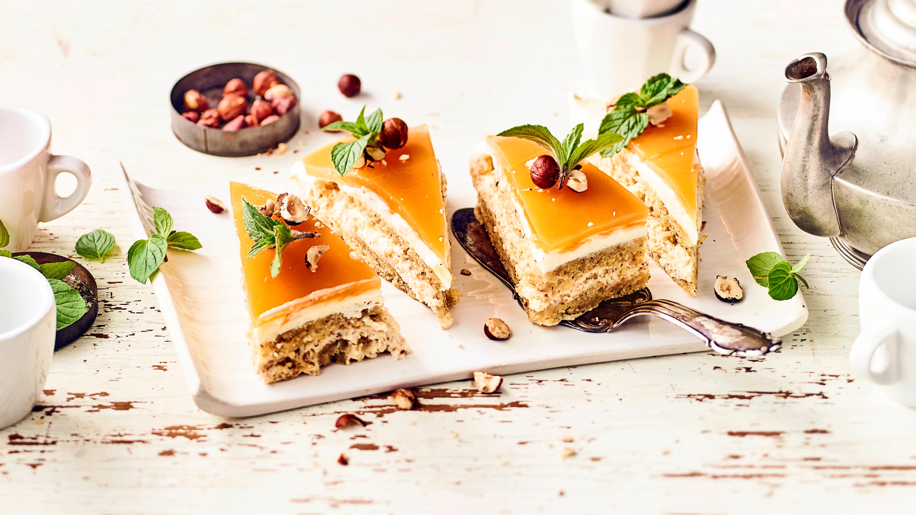 Haselnuss-Aprikosenschnitten Leckerer Haselnuss-Biskuitboden mit Sahnecreme und Aprikosenguss macht unsere Haselnuss-Aprkosenschnitten besonders cremig und lecker!