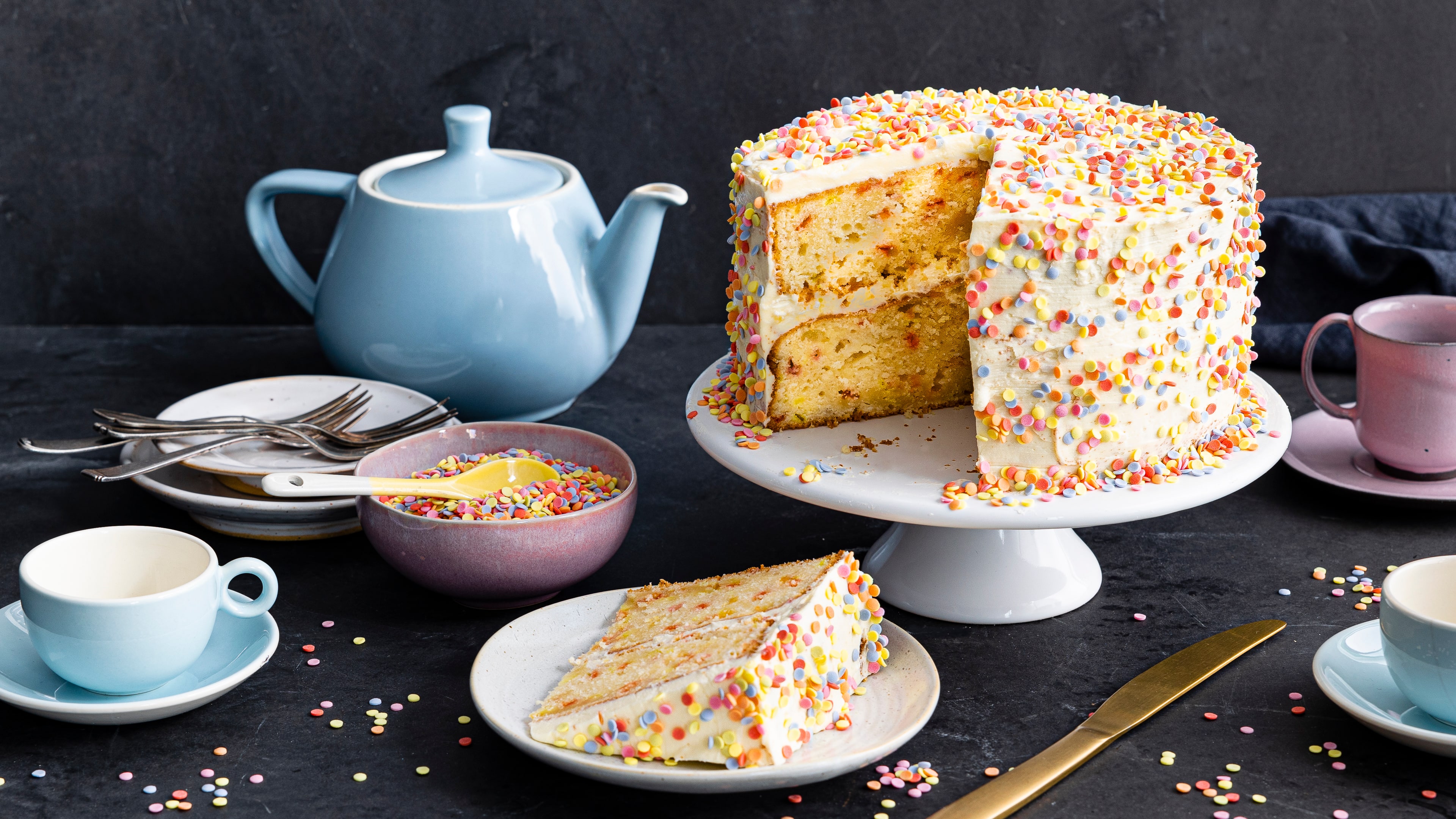 Rezept für Konfetti Kuchen Heller fluffiger Kuchen mit weißer Creme und buntem Konfetti auf einer Kuchen-Etagere