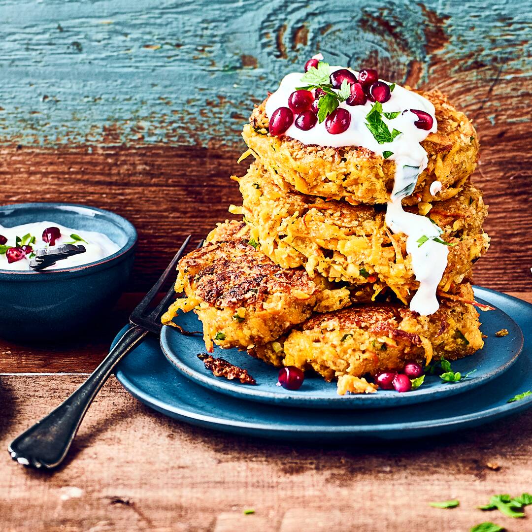 Unser Rezept für raffinierte Kürbis-Vanille-Bratlinge mit Paprika und Granatapfel-Joghurt-Dip ist vegan und schnell zubereitet – gleich ausprobieren!