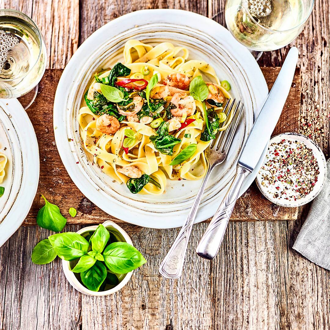 Schnelles Pastagericht mit Meeresfrüchten: Probieren Sie unsere Linguine mit Scampi, Spinat und Peperoni in Kokos-Soße – pikant und lecker!