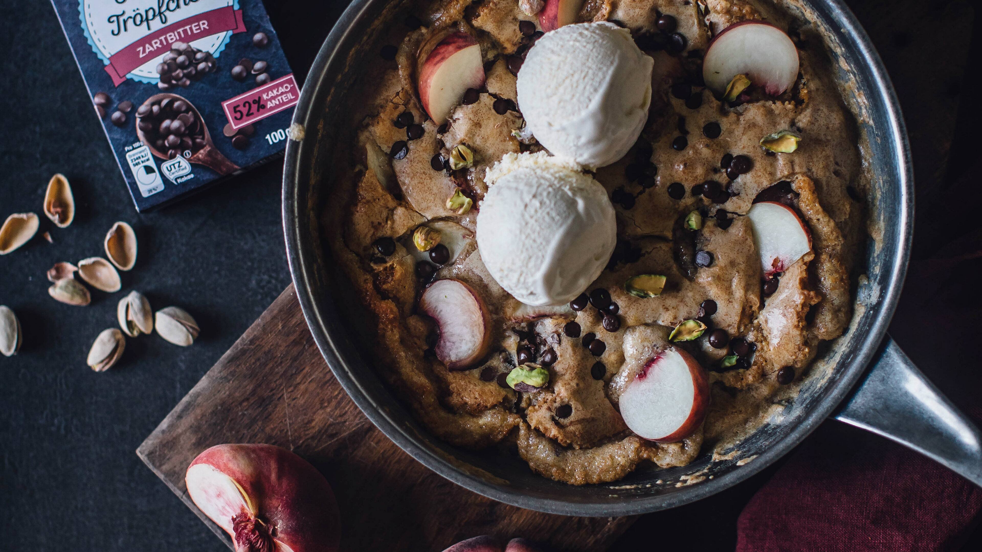 Ein Cookie aus der Pfanne? Unbedingt! Unser leckerer Pfannen-Cookie mit Schokotropfen und Vanilleeis bringt alle Herzen zum Schmelzen!
