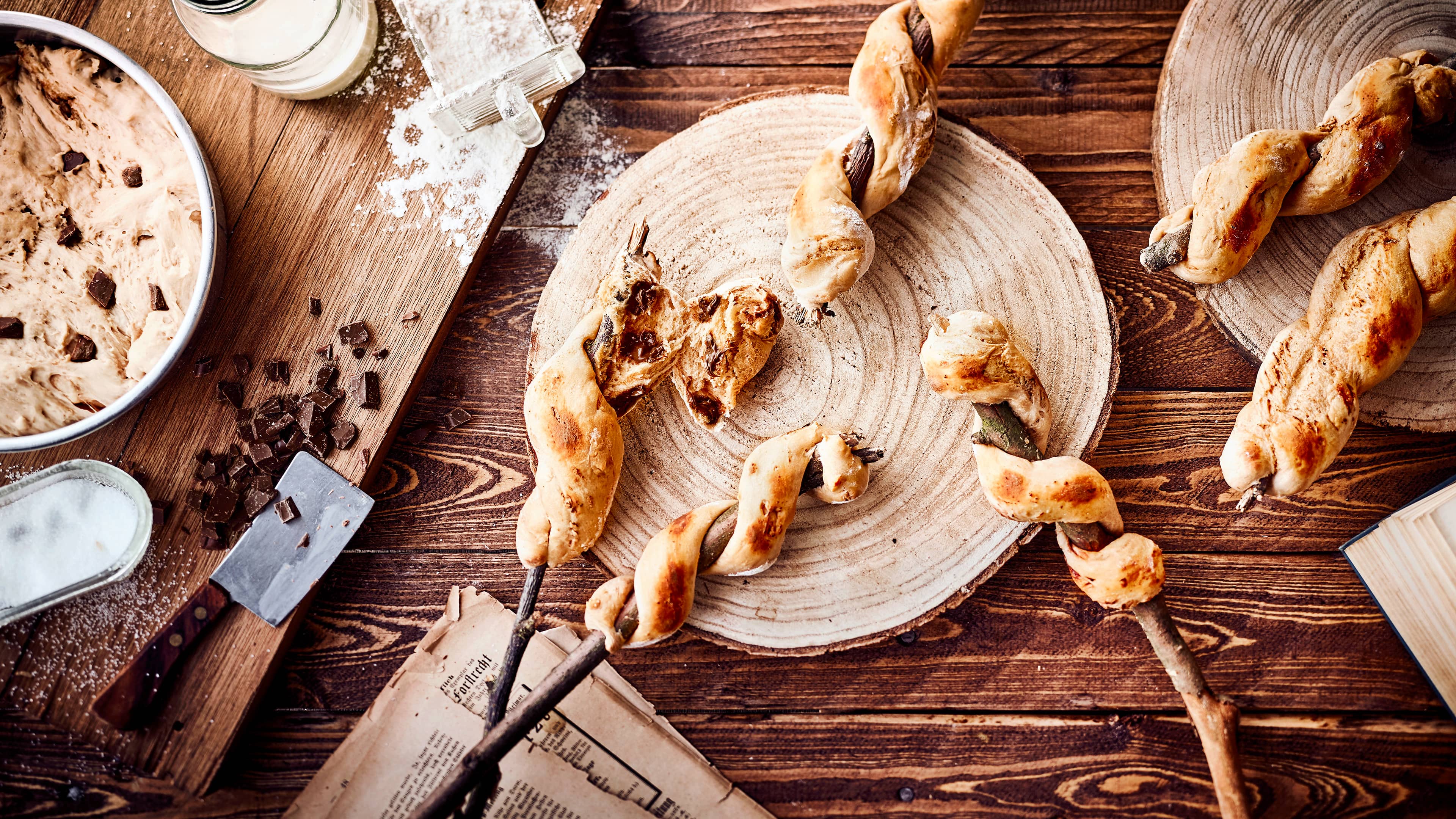 Gesellig zusammensitzen und warmes Stockbrot genießen. In unserer Version sogar mit leckeren Schokoladenstücken.