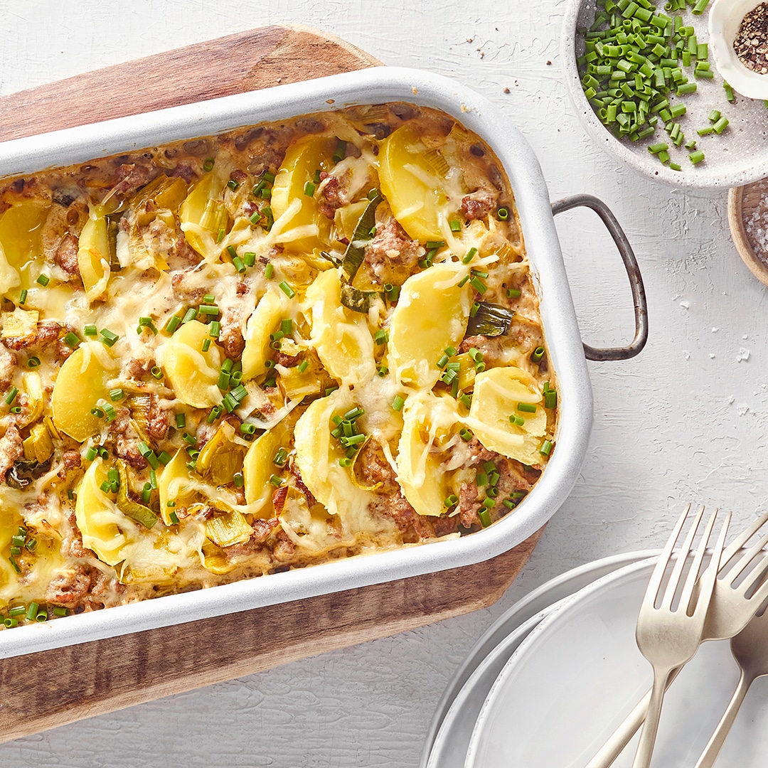 Auflaufform mit Hack, Kartoffelscheiben, überbackenem Käse und Schnittlauch.